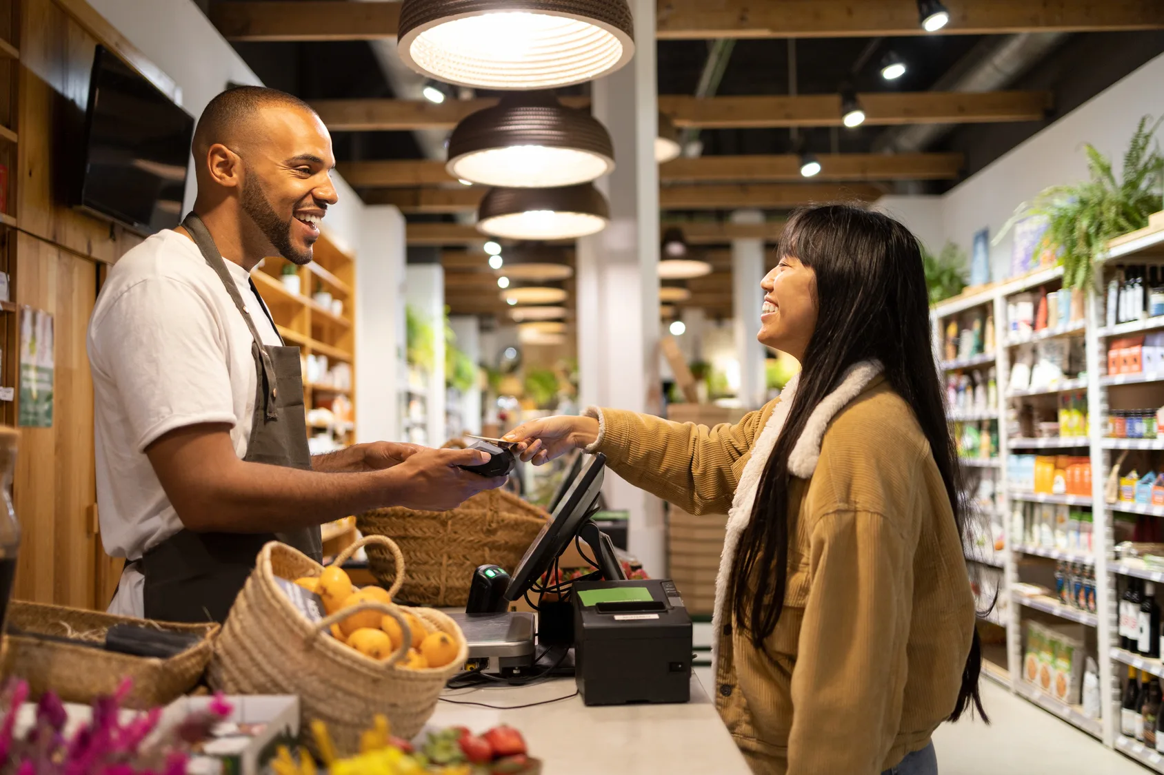 Woman makes contactless payment with credit card at store