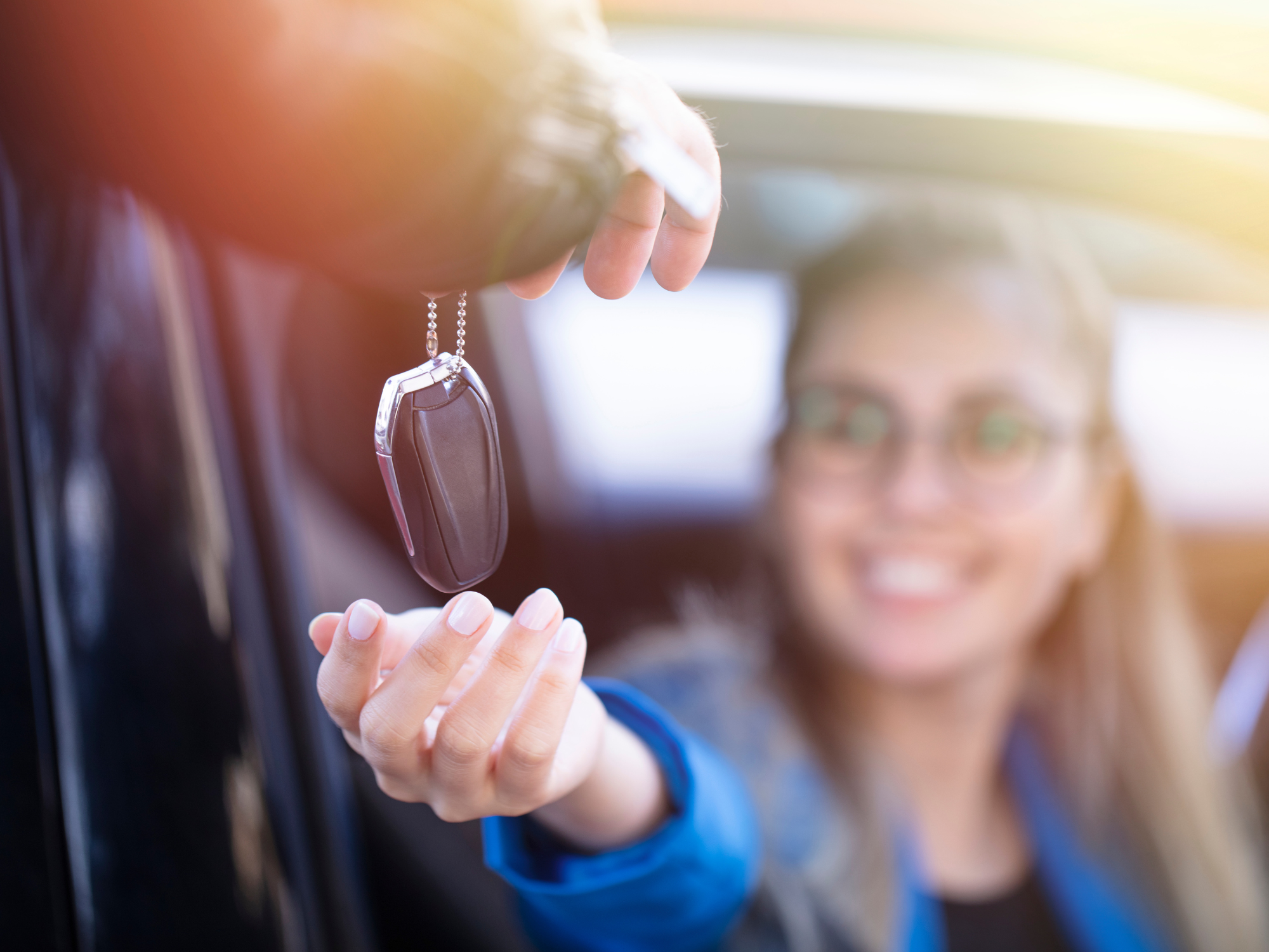 Woman getting keys to a new car